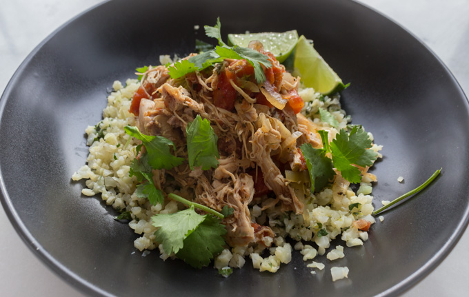 Mexican Chicken with Cilantro Lime Cauliflower Rice in a Black Bowl